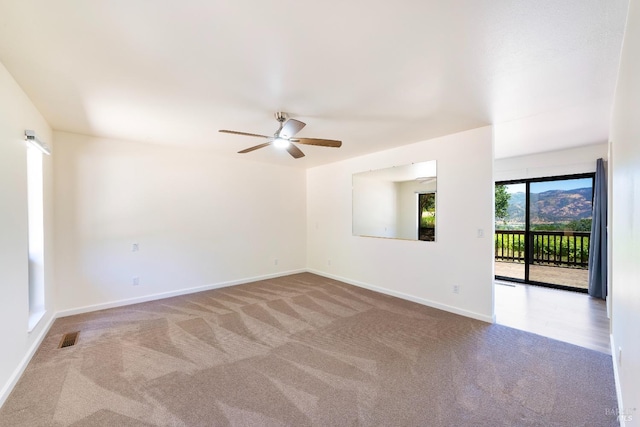 carpeted empty room with ceiling fan