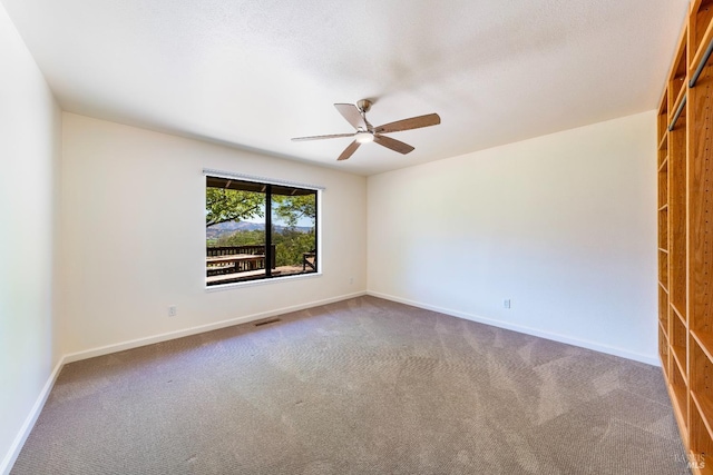 empty room with carpet flooring and ceiling fan