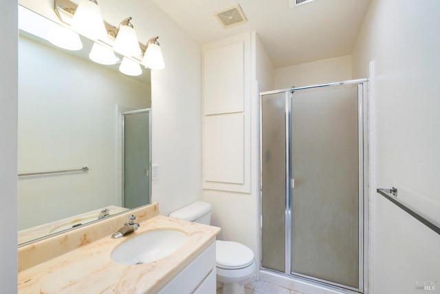 bathroom with an enclosed shower, vanity, and toilet