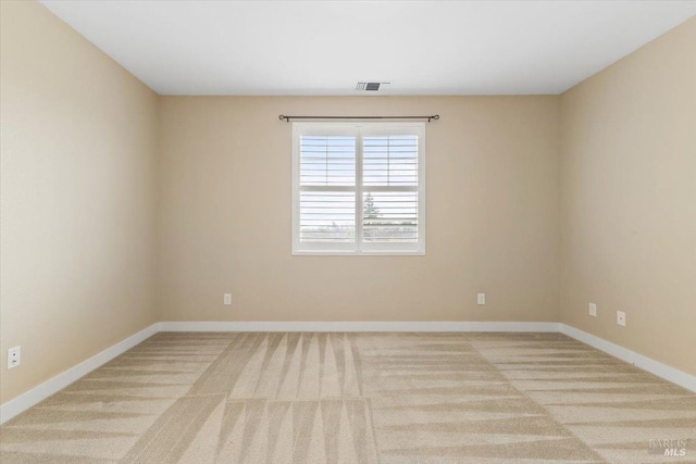 carpeted empty room with baseboards and visible vents