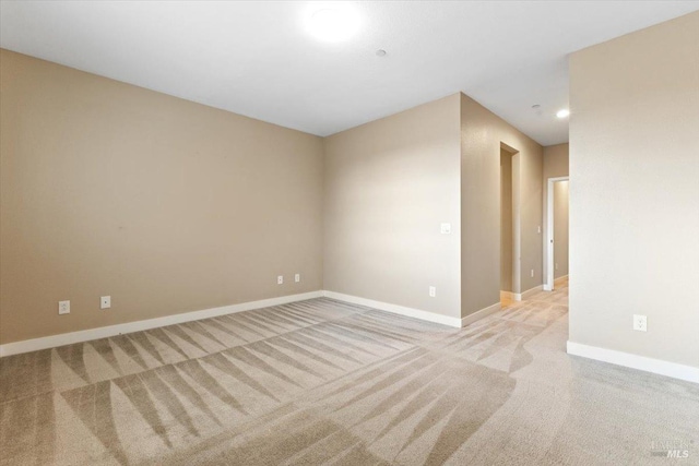 carpeted spare room with recessed lighting and baseboards