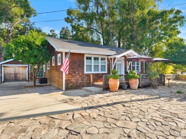 view of front of property featuring a storage shed and an outdoor structure