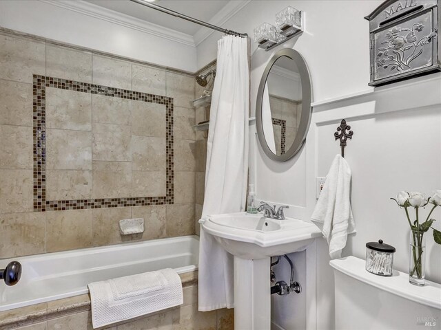 bathroom with crown molding, shower / tub combo with curtain, and toilet