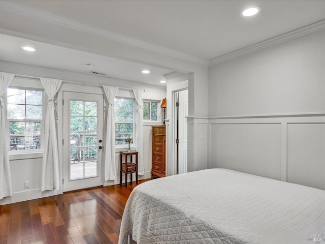 bedroom with crown molding, visible vents, dark wood-type flooring, wainscoting, and access to outside