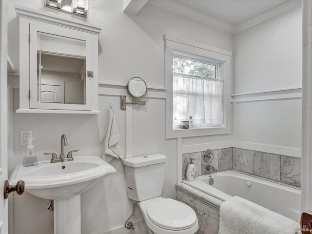 full bath with a sink, ornamental molding, a garden tub, and toilet