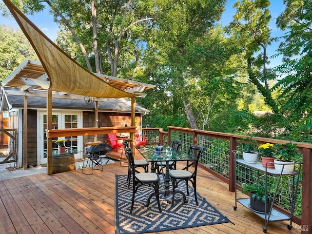 wooden terrace with outdoor dining space and a pergola