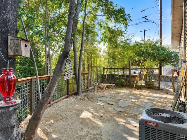 view of yard with a patio area, cooling unit, and fence