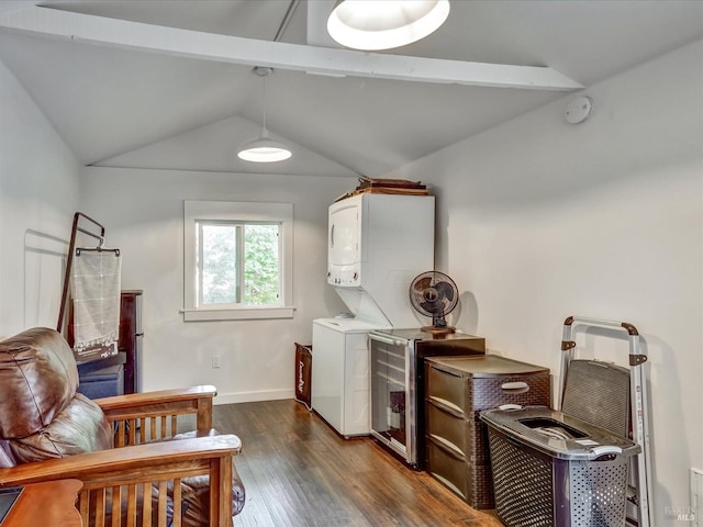 washroom with stacked washer / drying machine, laundry area, dark wood finished floors, and baseboards