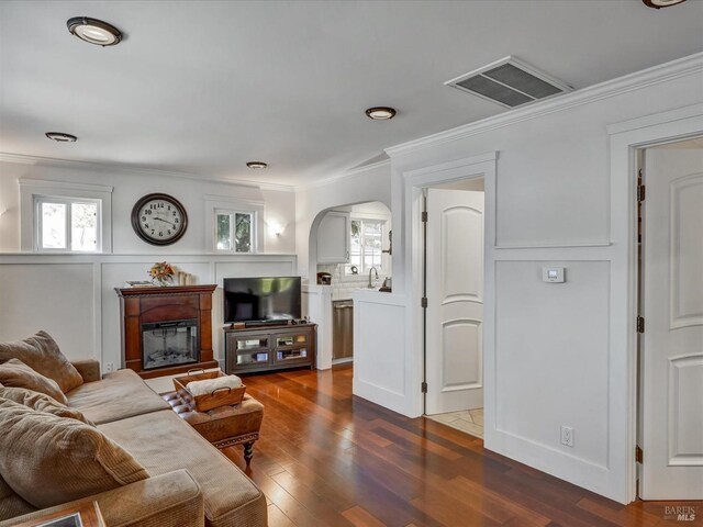 living room featuring ornamental molding and dark hardwood / wood-style flooring