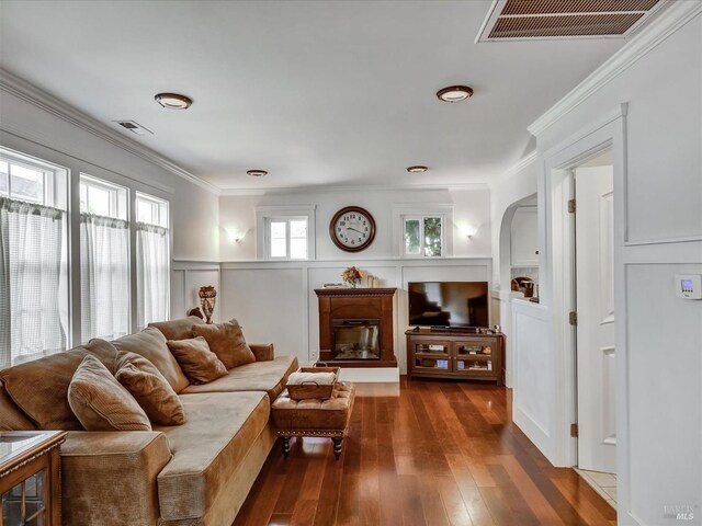 living room featuring dark hardwood / wood-style flooring and crown molding