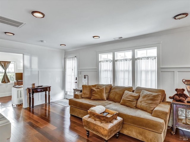 living room featuring visible vents, dark wood finished floors, and a wealth of natural light