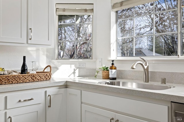 kitchen featuring white cabinetry and sink