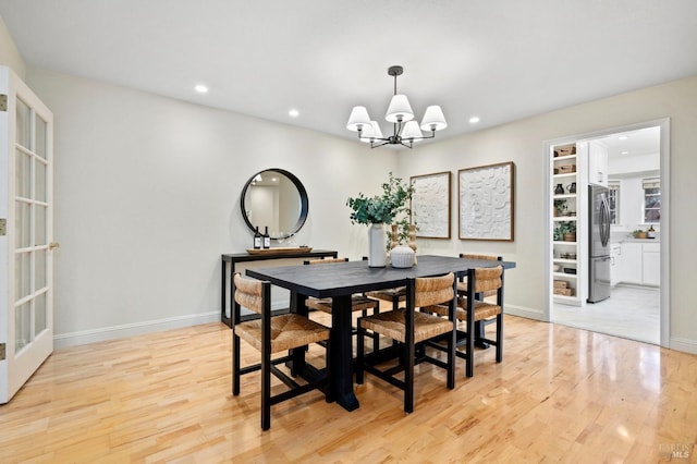 dining room featuring an inviting chandelier and light hardwood / wood-style floors