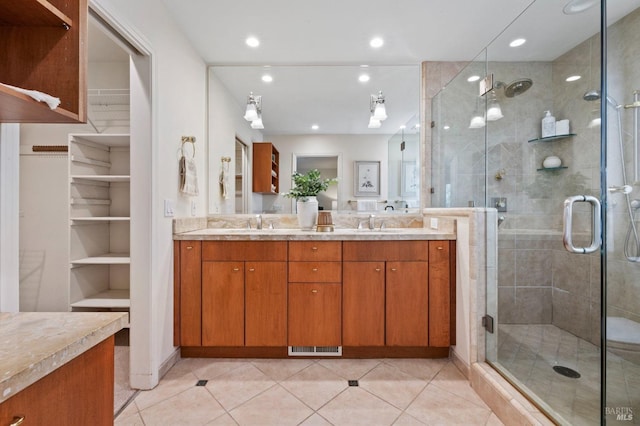 bathroom featuring walk in shower, vanity, and tile patterned flooring