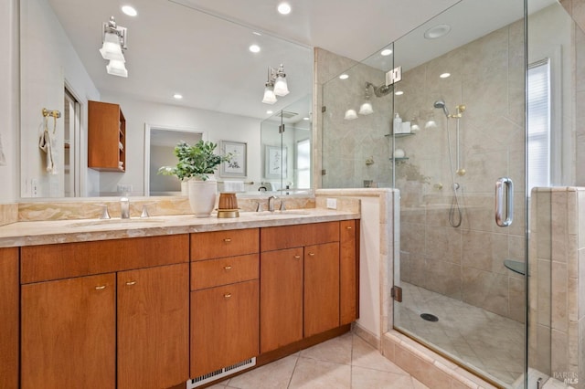 bathroom with walk in shower, tile patterned floors, and vanity