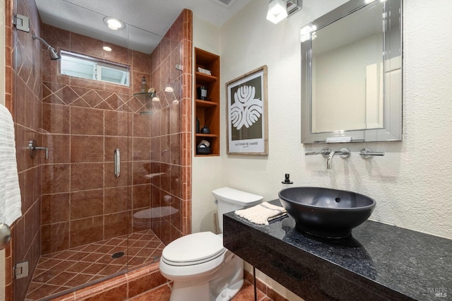 bathroom featuring sink, an enclosed shower, and toilet