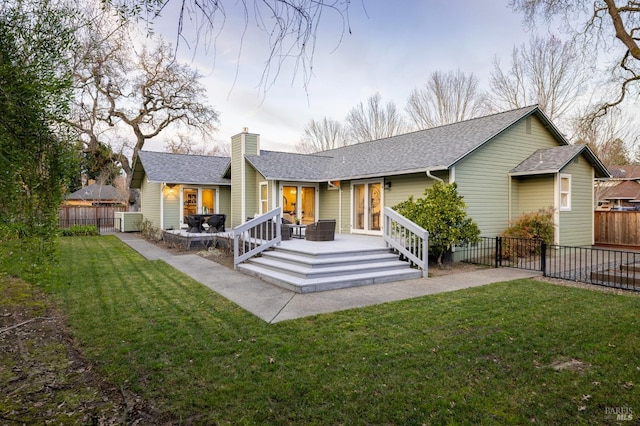 rear view of property featuring a patio, a yard, and cooling unit