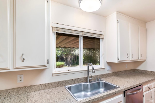 kitchen featuring sink, stainless steel dishwasher, and white cabinets