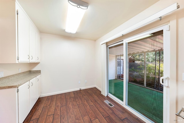 unfurnished dining area featuring dark hardwood / wood-style floors