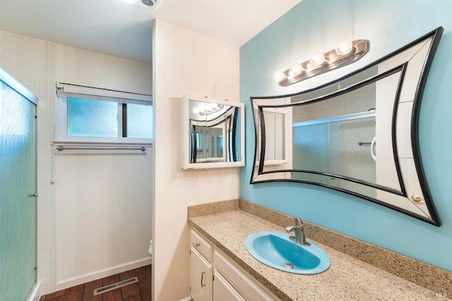 bathroom with walk in shower, vanity, toilet, and hardwood / wood-style flooring