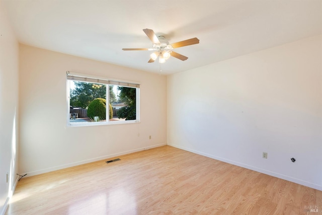 unfurnished room with ceiling fan and light wood-type flooring