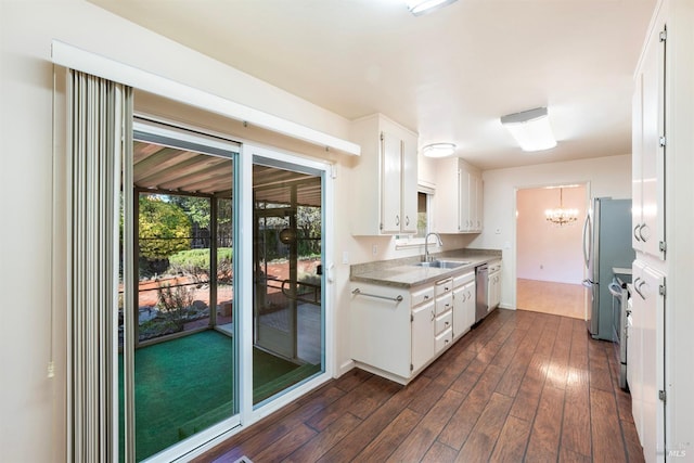 kitchen featuring dark hardwood / wood-style flooring, sink, white cabinets, and appliances with stainless steel finishes