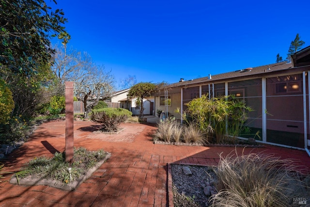 view of yard featuring a patio and a sunroom