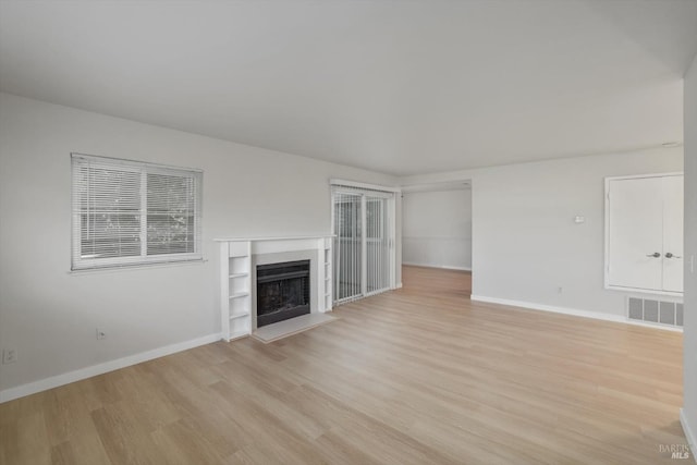 unfurnished living room with light wood-type flooring