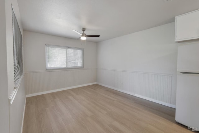 empty room featuring light hardwood / wood-style flooring and ceiling fan