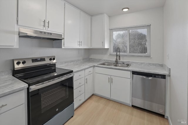 kitchen featuring white cabinetry, appliances with stainless steel finishes, sink, and light hardwood / wood-style floors