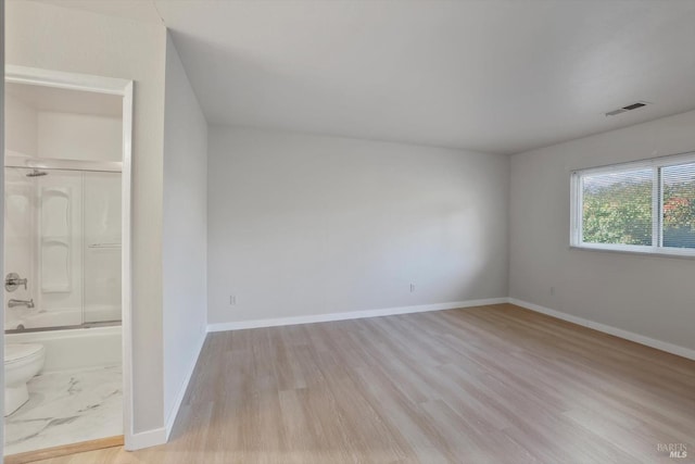 spare room featuring light hardwood / wood-style flooring