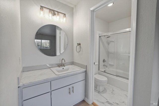 full bathroom featuring enclosed tub / shower combo, vanity, and toilet