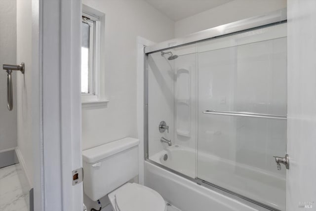 bathroom with toilet and combined bath / shower with glass door