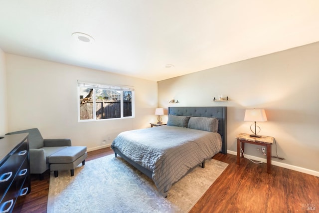 bedroom with dark hardwood / wood-style floors