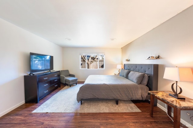 bedroom with dark hardwood / wood-style flooring