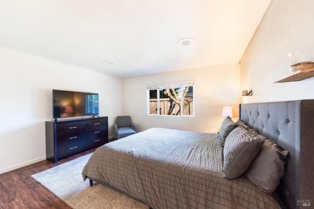 bedroom with dark hardwood / wood-style flooring