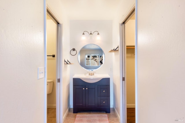 bathroom with vanity, toilet, and tile patterned flooring