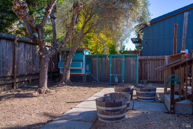 view of yard featuring an outbuilding and an outdoor fire pit