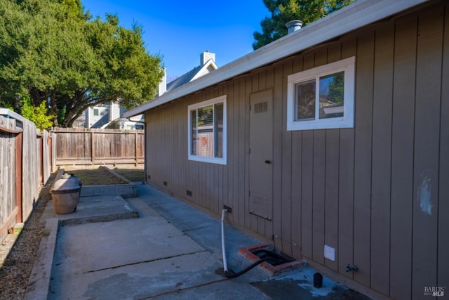 view of side of property with a patio area