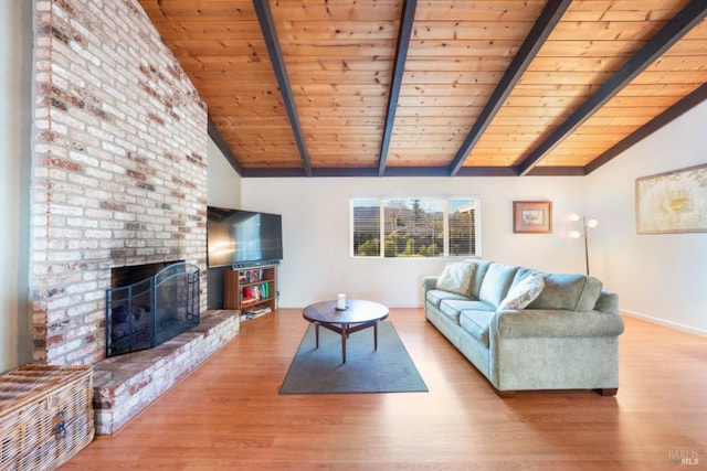 living room with wood ceiling, a fireplace, light hardwood / wood-style flooring, and vaulted ceiling with beams