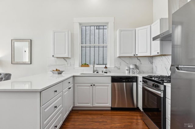 kitchen featuring white cabinetry, sink, backsplash, and appliances with stainless steel finishes