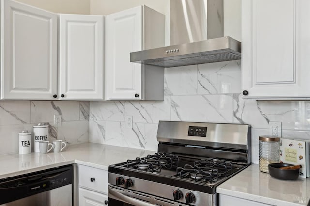 kitchen with tasteful backsplash, stainless steel appliances, white cabinets, and wall chimney exhaust hood