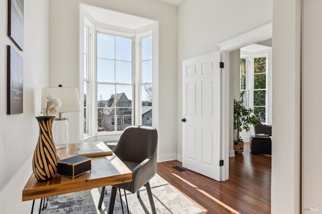 office with dark wood-type flooring