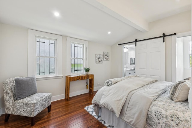 bedroom featuring connected bathroom, dark wood-type flooring, lofted ceiling with beams, and a barn door