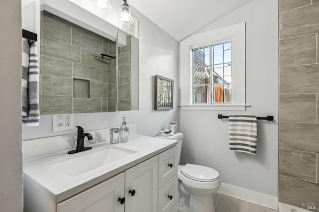 bathroom with vanity, toilet, and vaulted ceiling