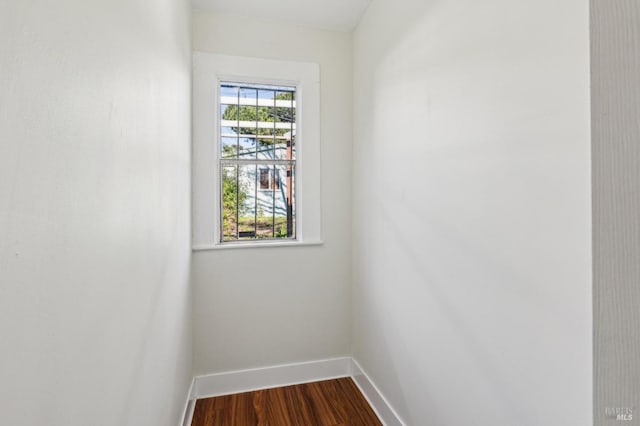 empty room with hardwood / wood-style floors and a wealth of natural light