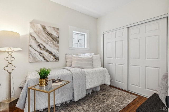 bedroom featuring dark hardwood / wood-style flooring and a closet