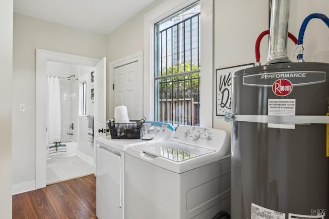 laundry room featuring secured water heater, dark wood-type flooring, and independent washer and dryer