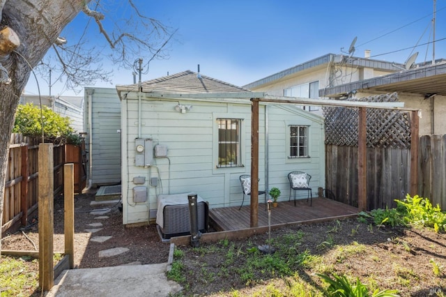 back of house featuring a wooden deck and cooling unit