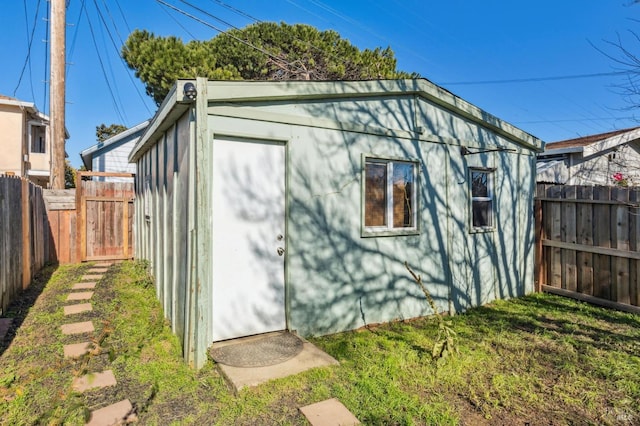 view of outbuilding with a yard